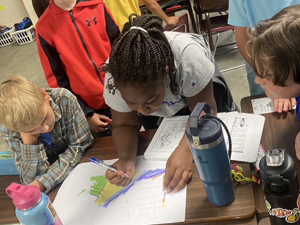 Students in Miss Simpson's 4th Grade class are seen here working on Virginia maps as a cumulative project identifying regions, major waterways, as well as each region's top products and industries. 