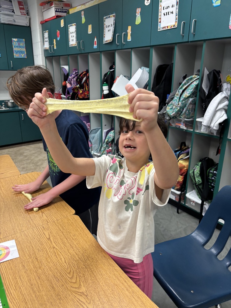 Student stretching slime triumphantly