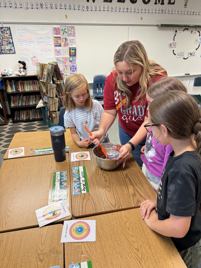Mrs. Burgh helps students mix slime for an experiment