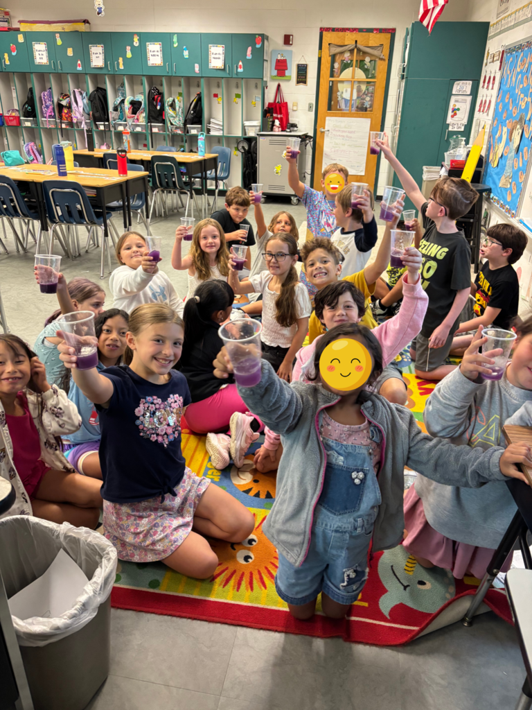 Students holding up their glasses of color changing lemonade!