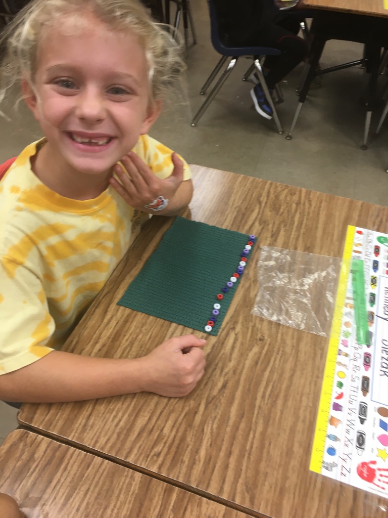 girl in a yellow shirt showing off her pattern