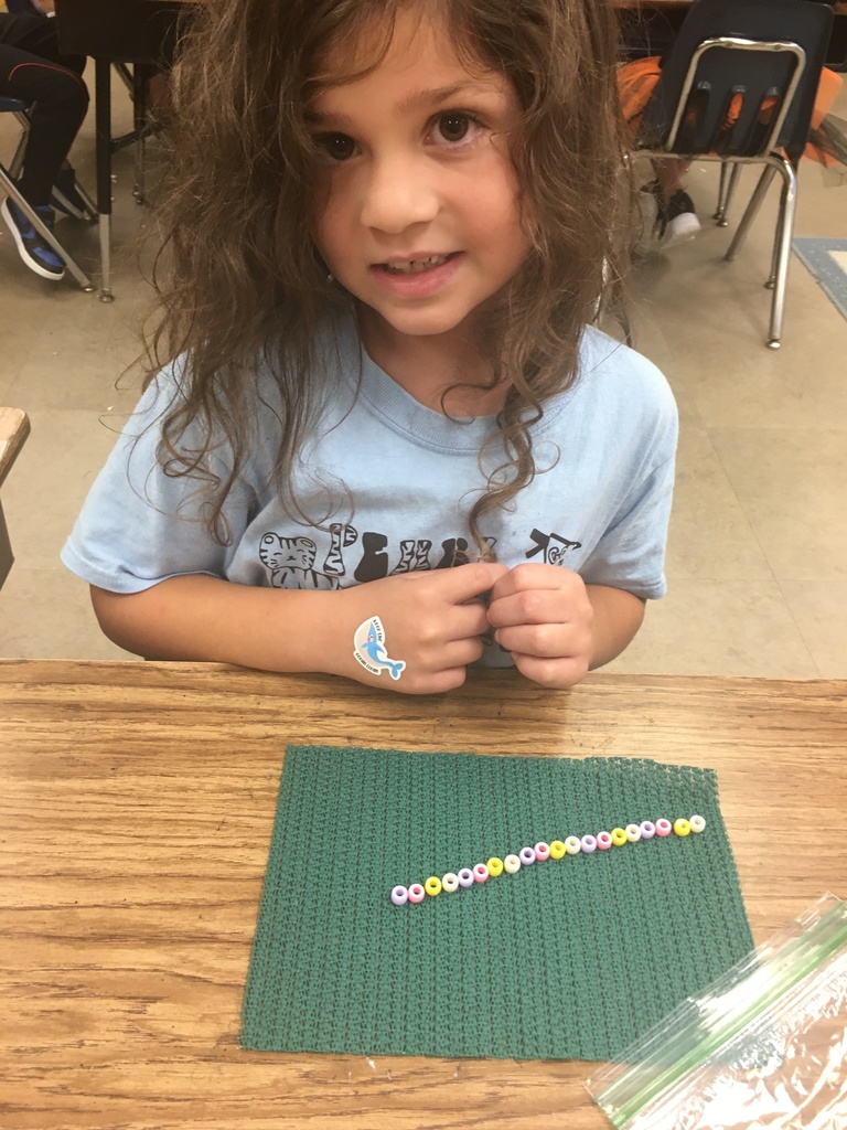 girl in a blue shirt showing off her pattern