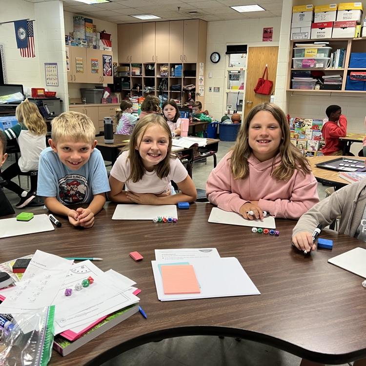 Mrs McFarlands class poses for pictures while playing a place value game