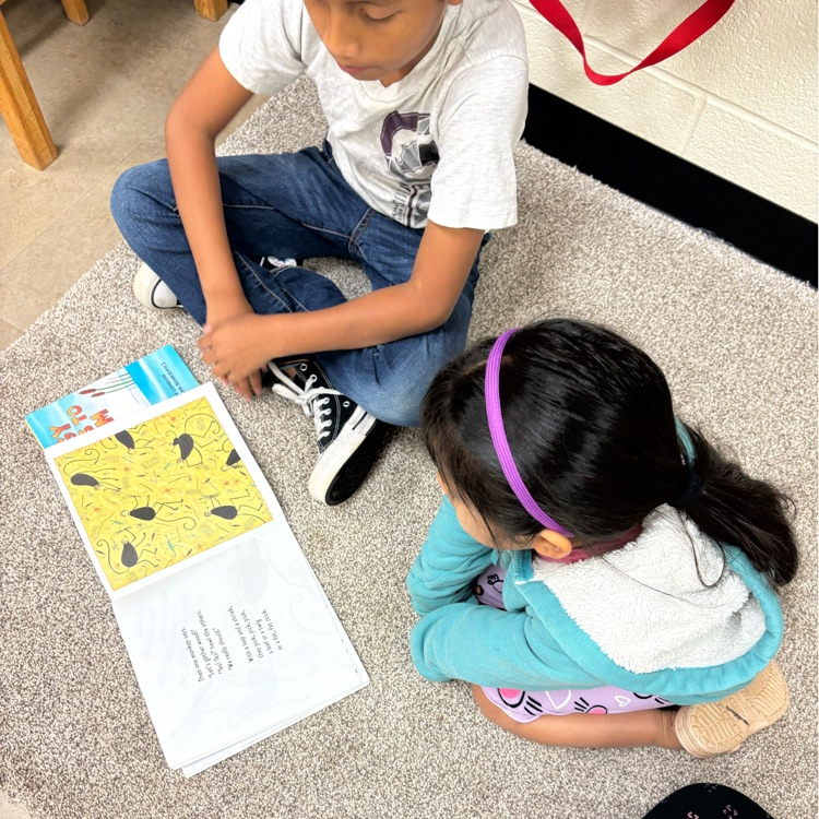 two students reading together.