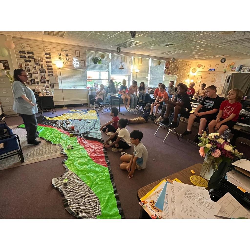 Students seated and engaged as Mrs. DeNicola explains the regions activity using the floor map.