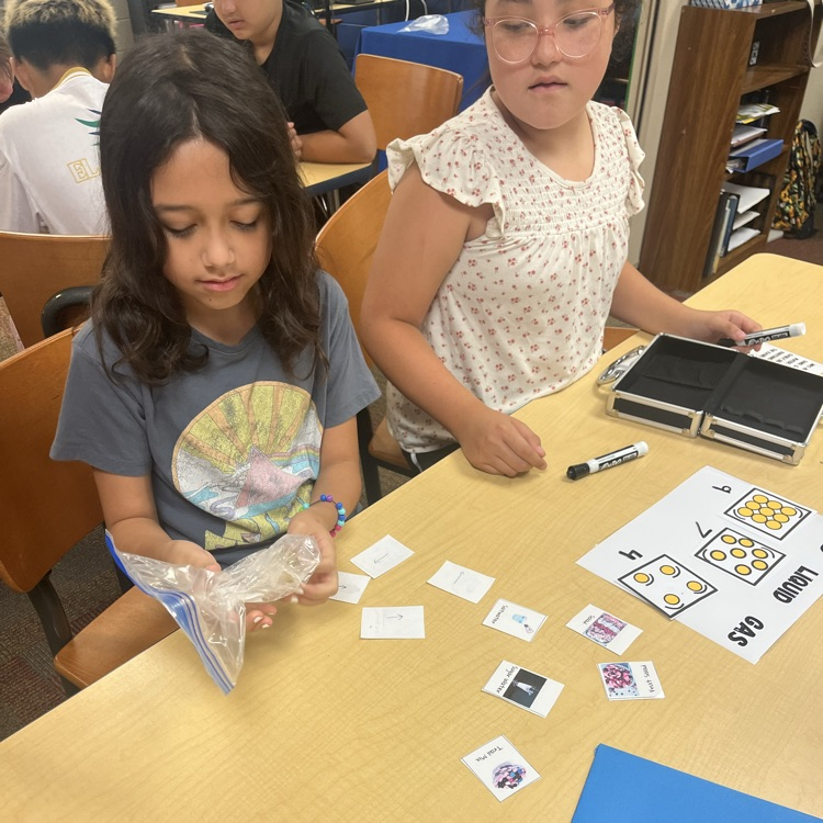 a student holds a baggie with an ice cube inside and contemplates how to melt the ice to get the key that is frozen inside 