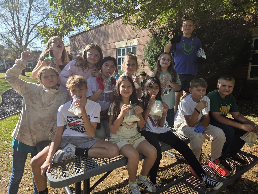 Fifth grade students in Mrs. Guinn’s class conduct science activities for a matter unit. Some students are indoors mixing colorful Oobleck in bowls, smiling as they hold up their mixtures. Others are outdoors in the school courtyard holding plastic bags of homemade ice cream, wearing gloves, and posing together in groups. The photos show engaged students enjoying hands-on experiments with both messy mixtures and edible treats.