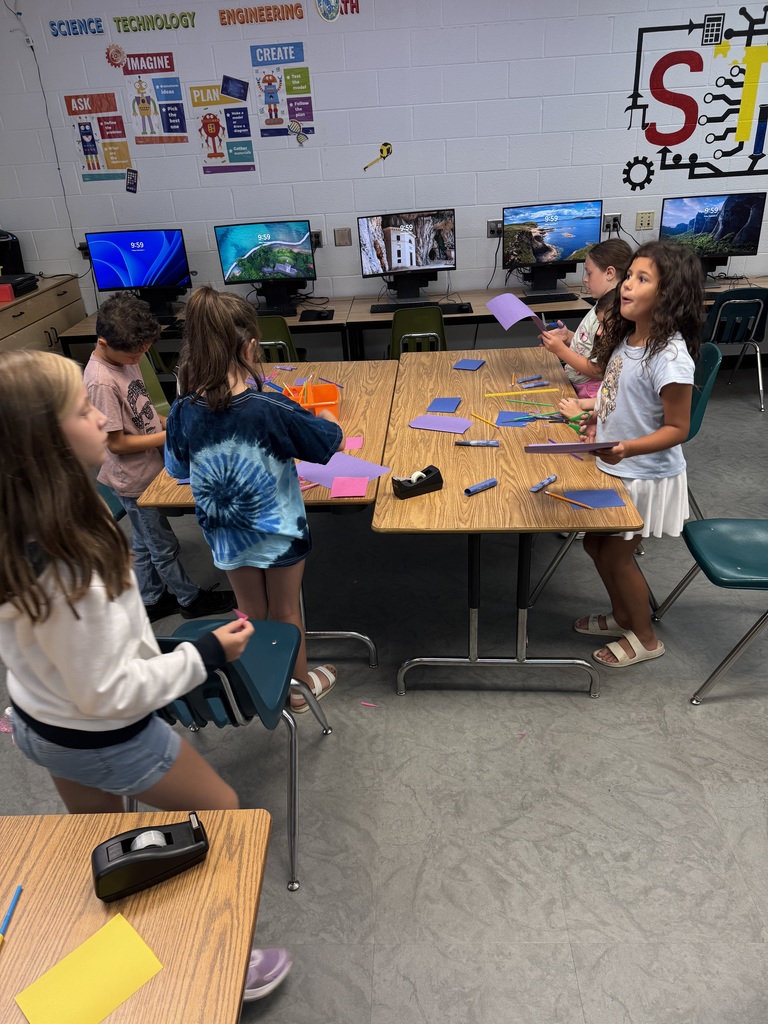 Students building paper rockets in STEM lab
