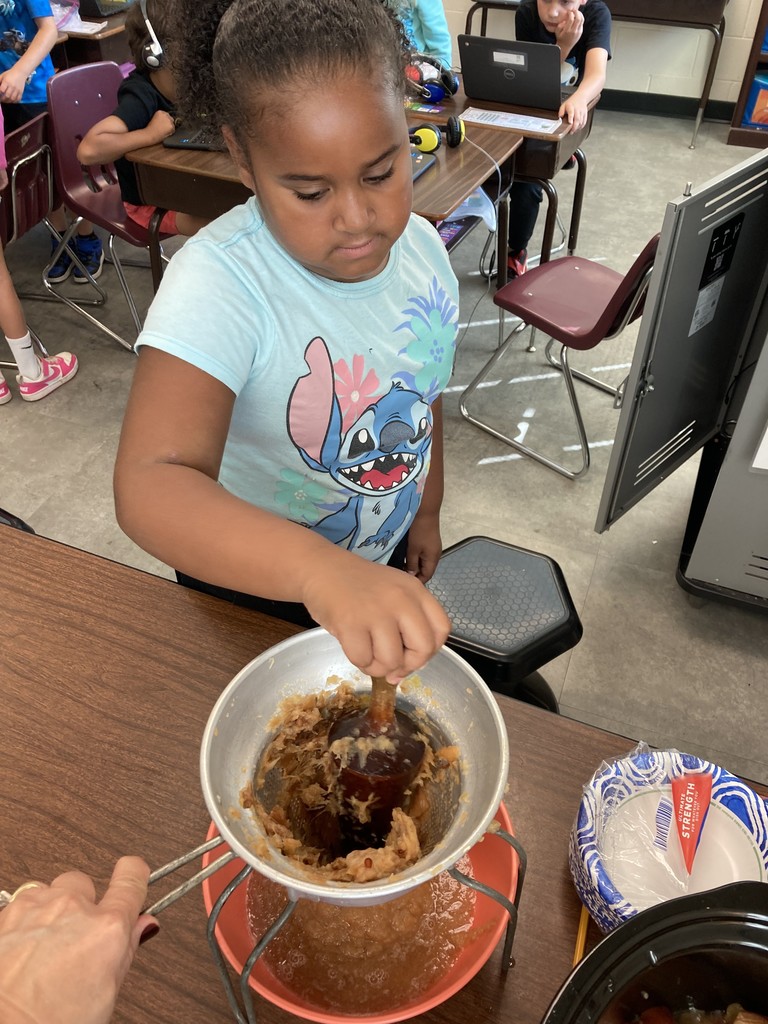 Pictured here are Mrs. Aylor's 2nd Graders making and enjoying some applesauce!