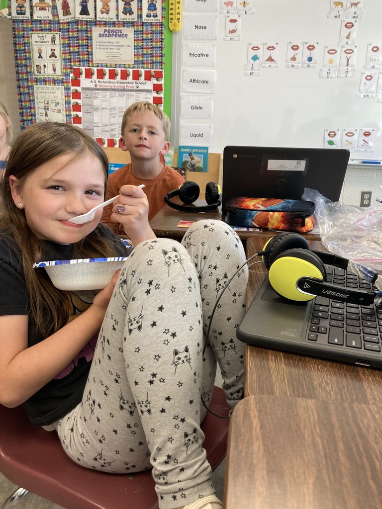 Pictured here are Mrs. Aylor's 2nd Graders making and enjoying some applesauce!
