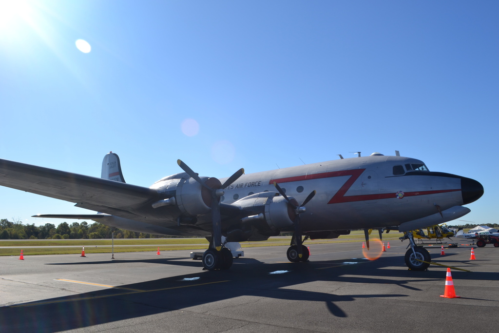 Image contains an airplane at the airport.  -AIR FORCE is on the side of the plane.