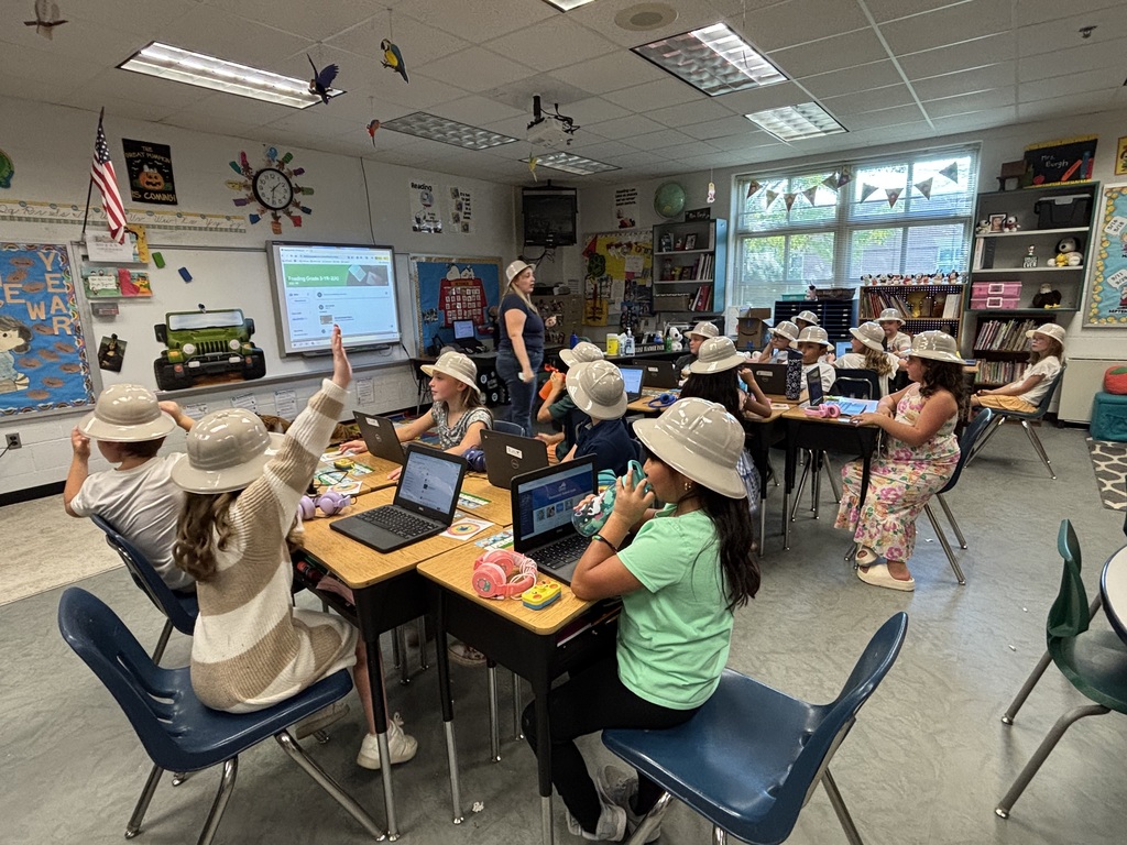 Third grade students participating in jungle themed activities in Mrs. Burgh's transformed jungle classroom.