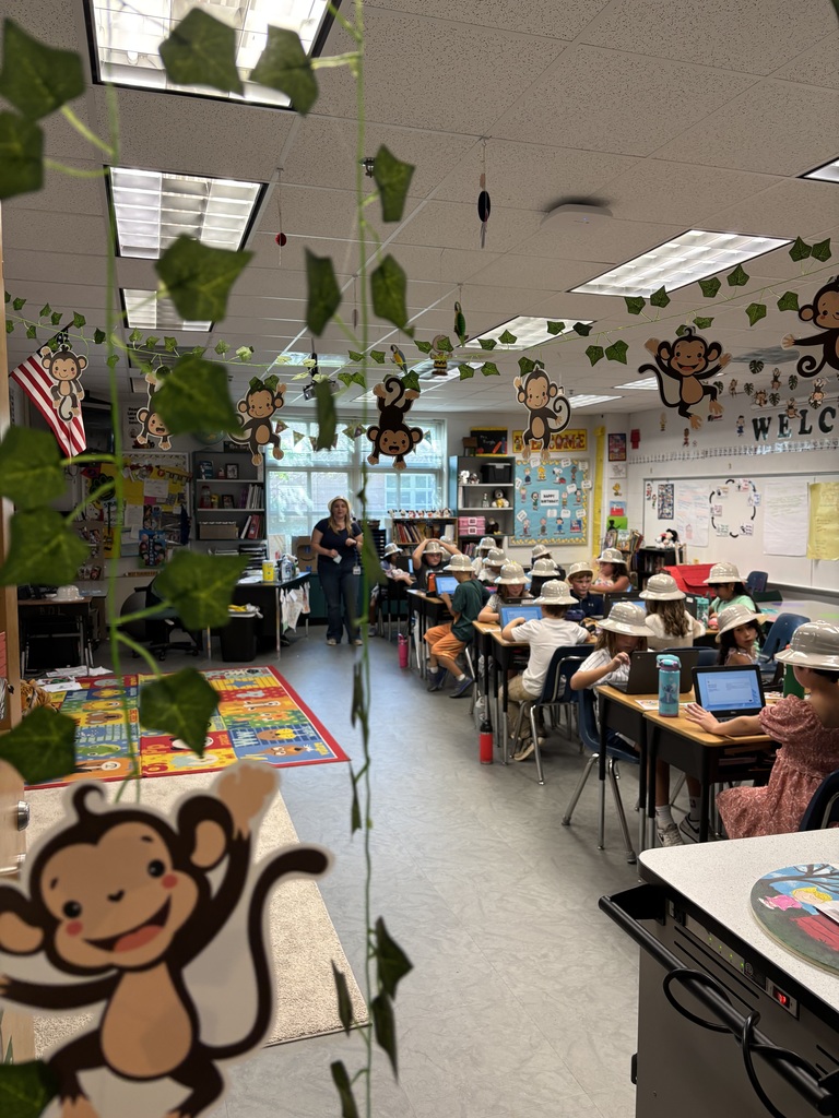 Third grade students participating in jungle themed activities in Mrs. Burgh's transformed jungle classroom.