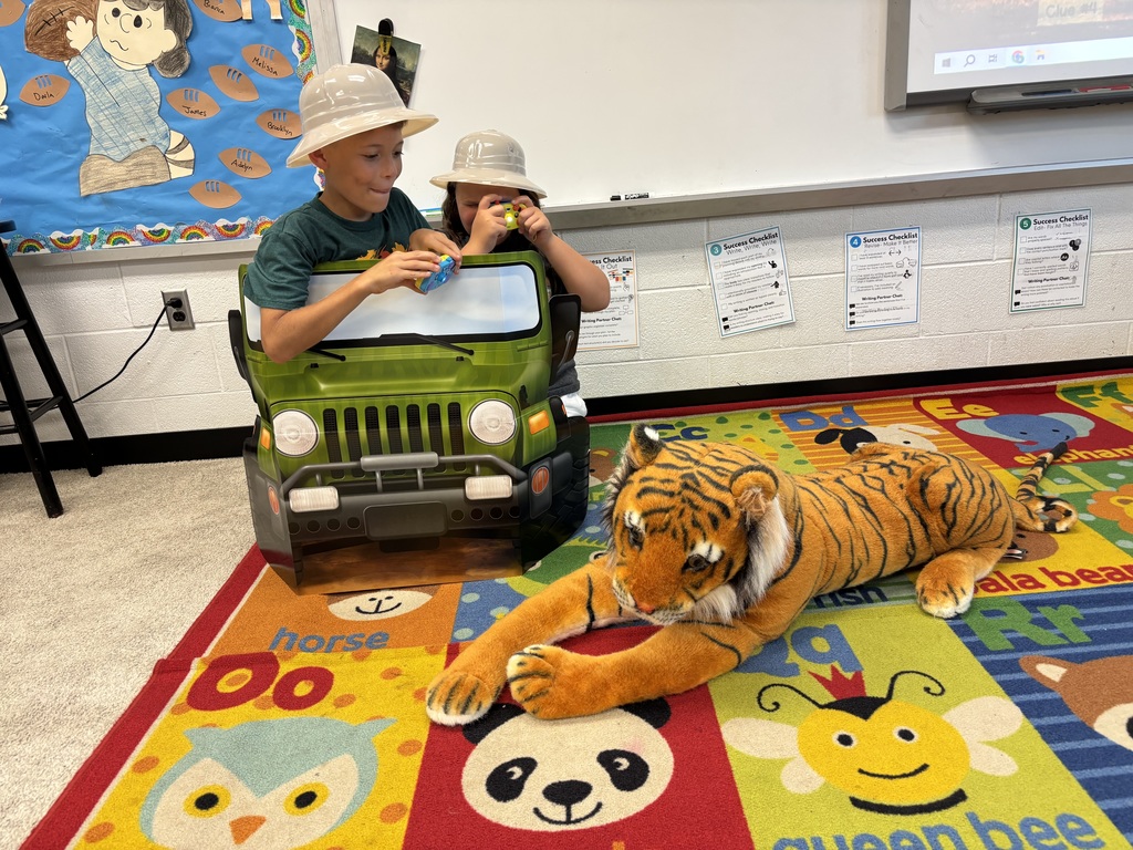 Third grade students participating in jungle themed activities in Mrs. Burgh's transformed jungle classroom.