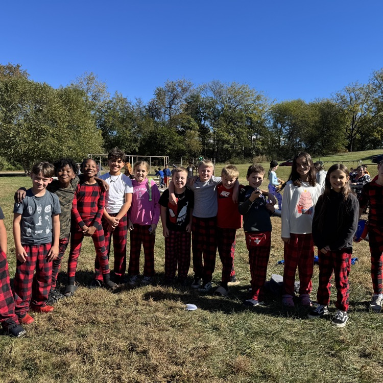 group of 4th graders all wearing red and black checkered pajama pants