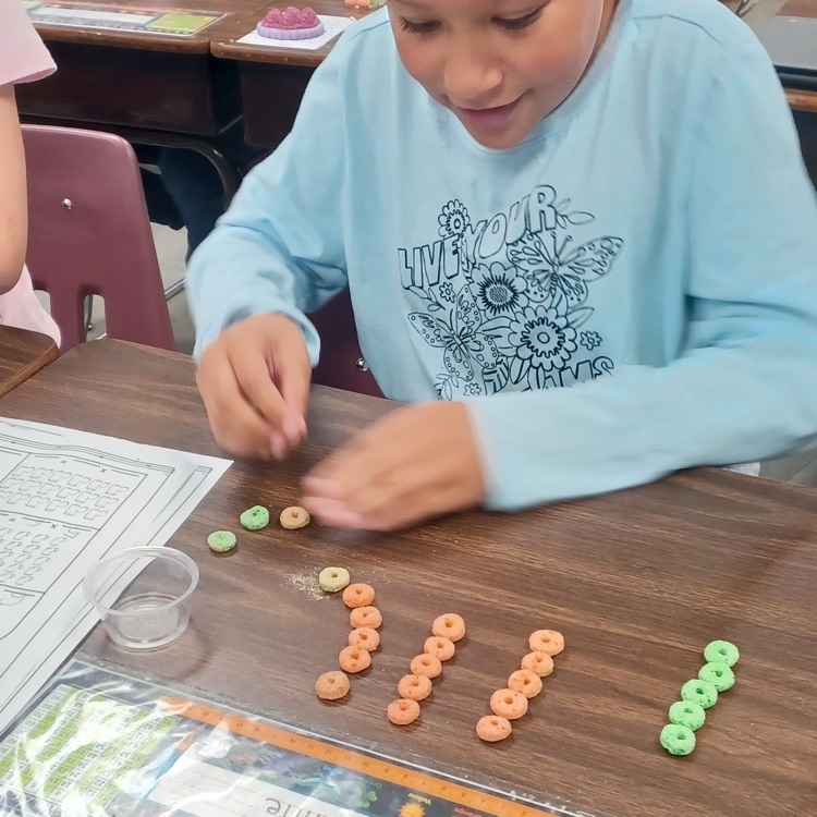 Meanwhile, down the hall in Ms. Ciccarone's third grade class, student   were using cereal to practice multiplication arrays.