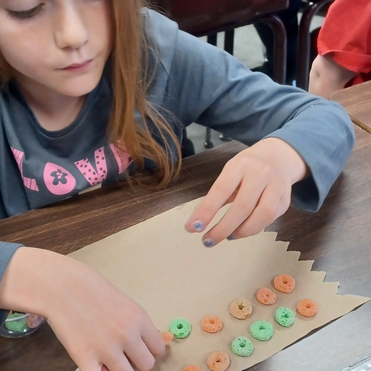 Meanwhile, down the hall in Ms. Ciccarone's third grade class, student   were using cereal to practice multiplication arrays.