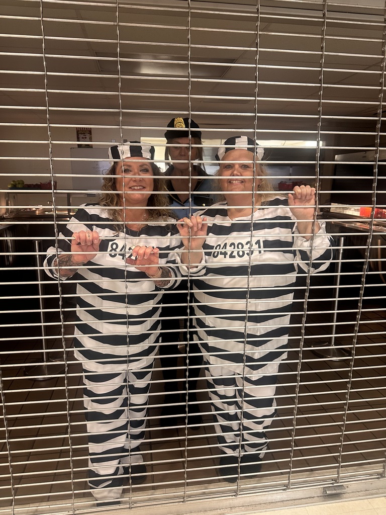 cafeteria staff wearing striped outfits behind bars