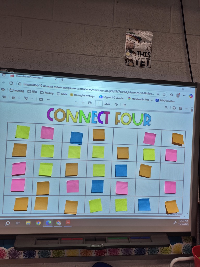 Students playing connect 4 on the smartboard