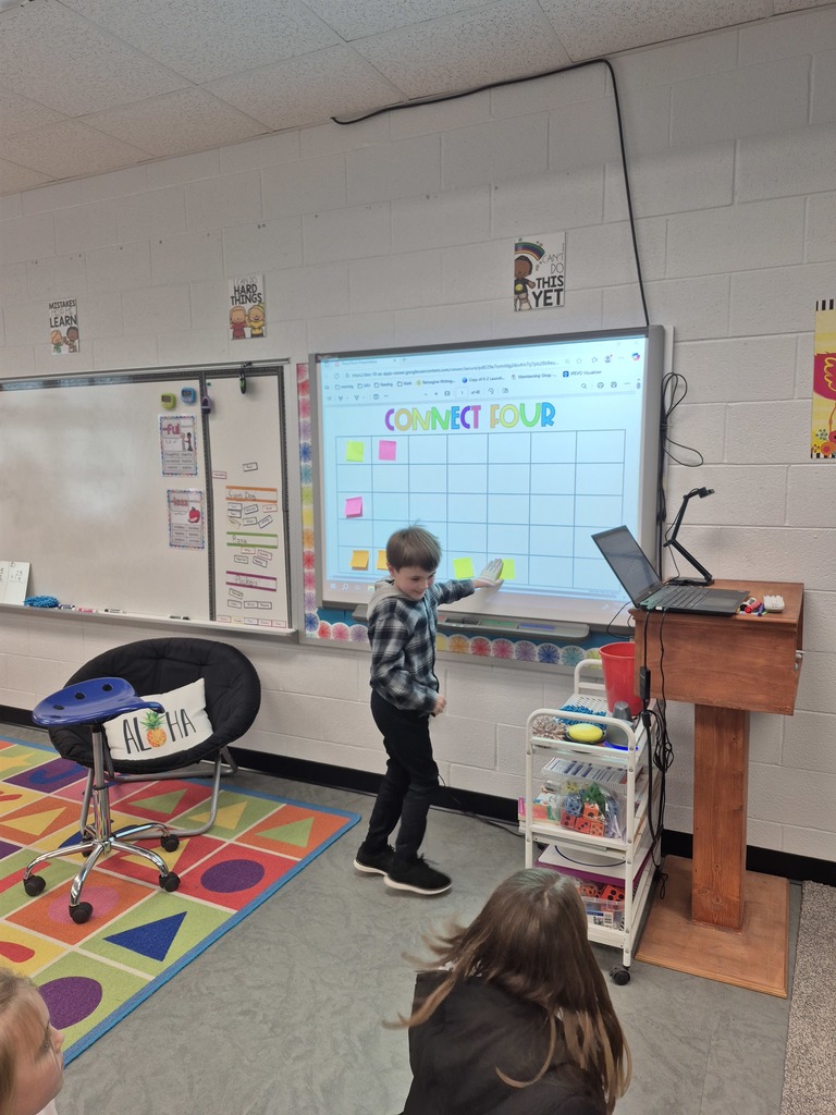 Student playing connect 4 on the smartboard