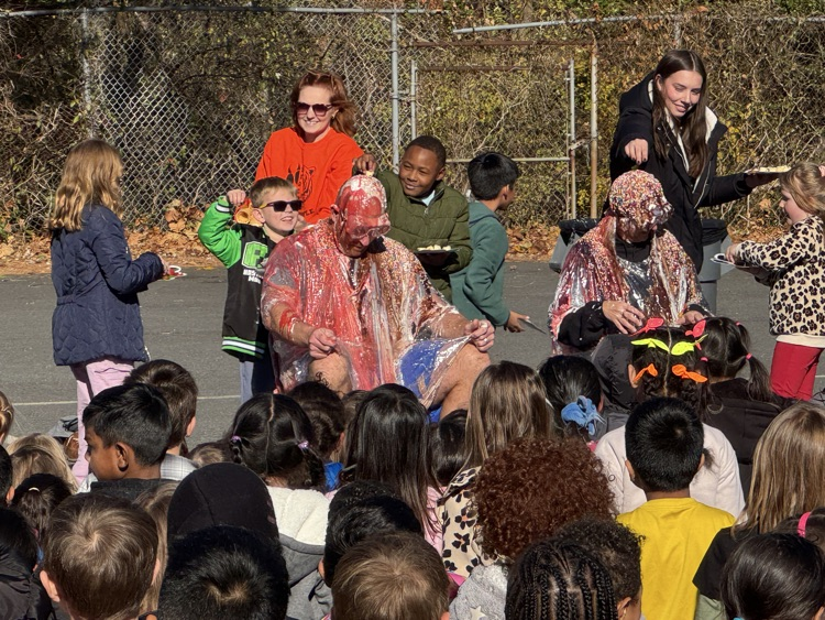 A group of students watching sprinkles being added to two adults