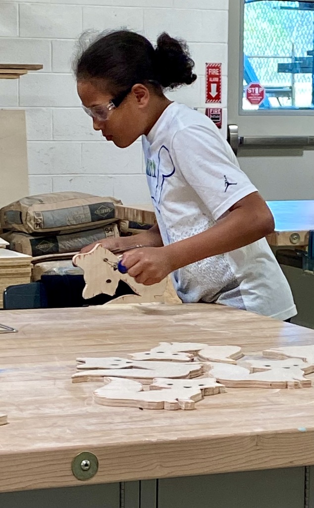 Student is learning carpentry skills in a technical class.