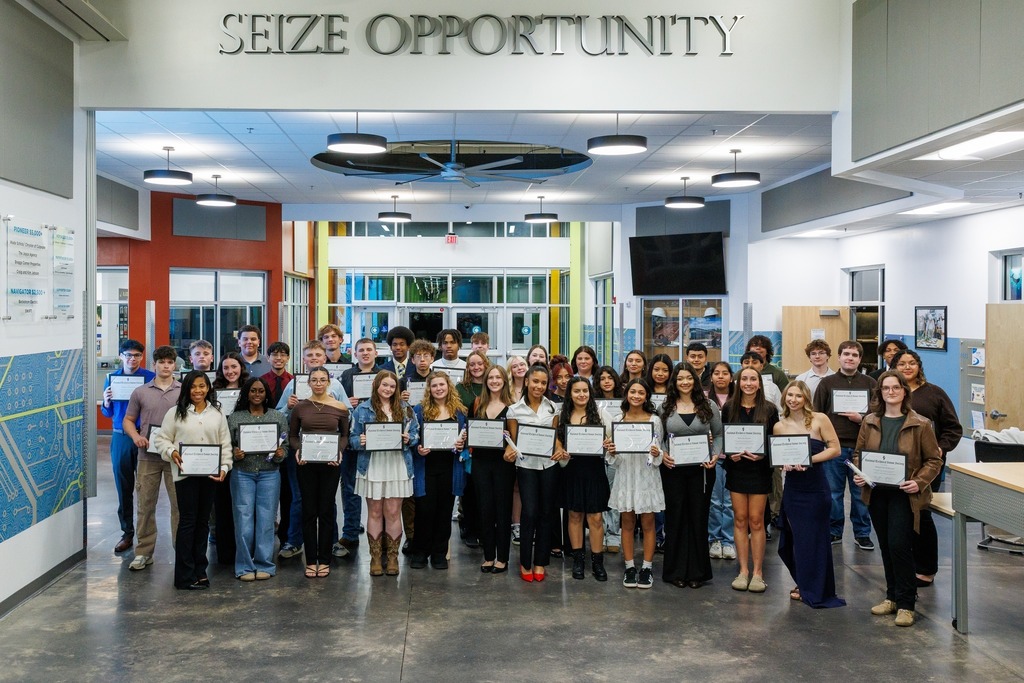 A large group of high school students and staff stand together in the Culpeper Technical Education Center’s main hallway under the “Seize Opportunity” sign. The students proudly hold certificates of recognition, smiling for a group photo after an awards ceremony.