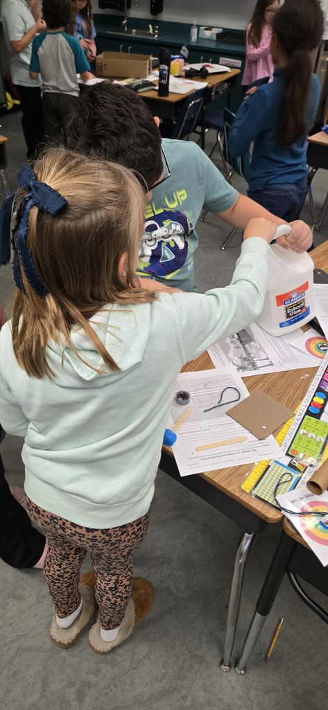 3rd graders building contraptions to solve a STEM challenge
