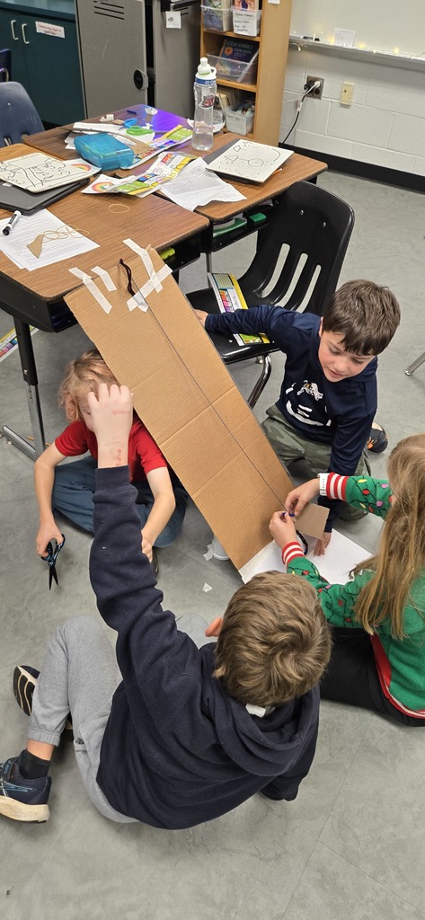 3rd graders building contraptions to solve a STEM challenge
