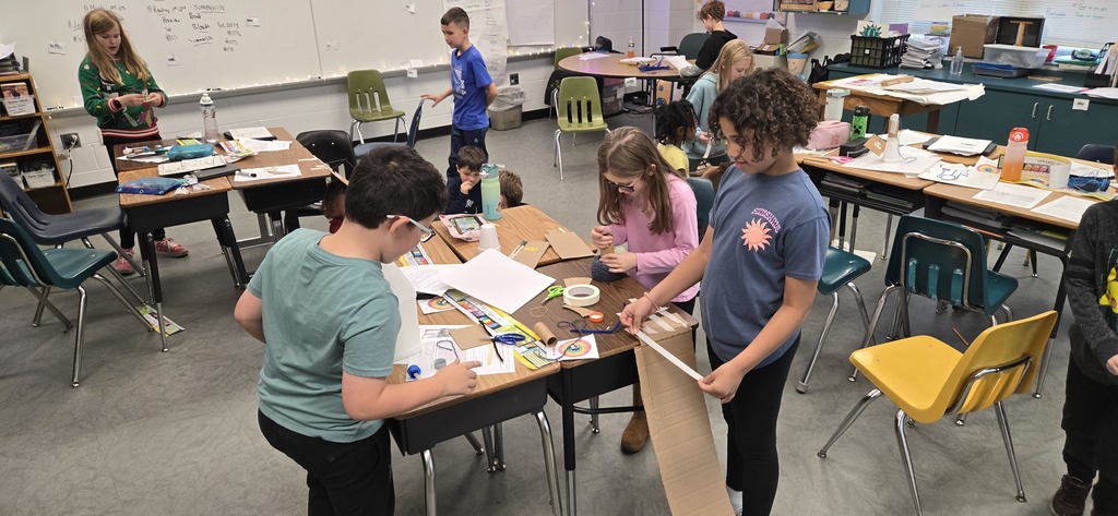 3rd graders building contraptions to solve a STEM challenge