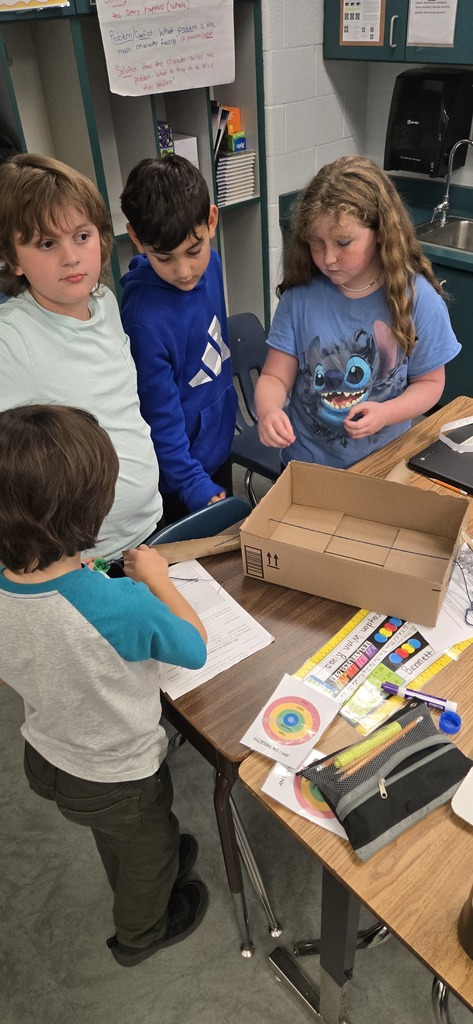 3rd graders building contraptions to solve a STEM challenge