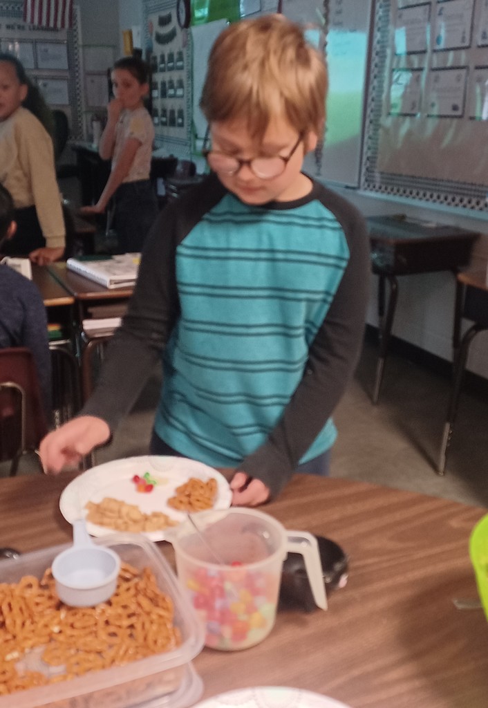 Several third grade classes watched The Charlie Brown Thanksgiving and then used measurement skills to create Snoopy’s recipe for Thanksgiving,  which includes jelly beans, toast, popcorn, and pretzels. Pictured are Ms. Ciccarone's class enjoying a yummy math class!