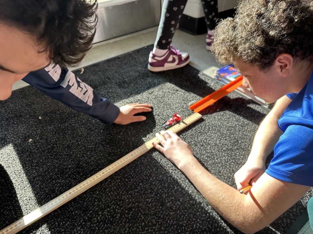 Students in Ms. Sheads' class are testing three different masses with force and motion. They are measuring the distance a cup traveled after rolling different sized balls into the cup! Everyone hypothesized correctly that the ball with more mass would push the cup furthest. Meanwhile, students in Mrs. Day's class also worked with the same concepts, except with ramps and cars.  Such great teaching and learning happens everyday at AGR!