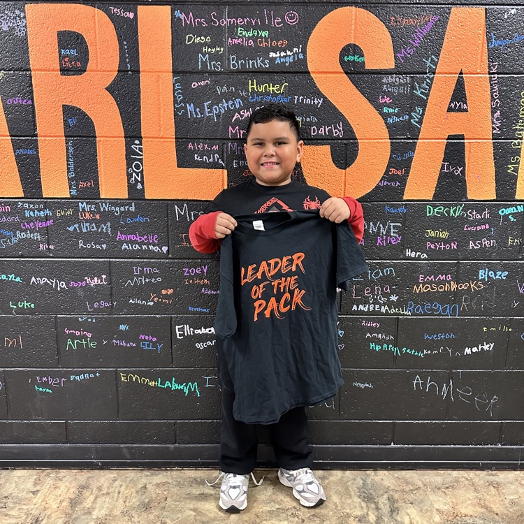 Student hold g leader of the pack shirt