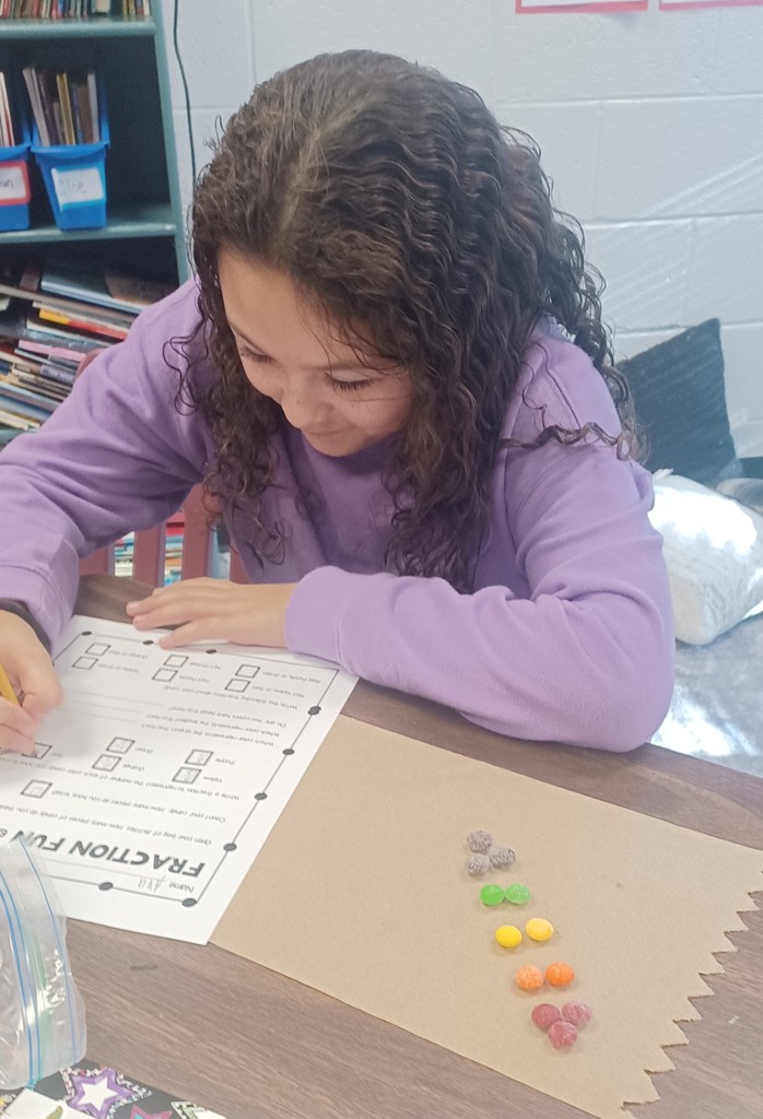 Pictured here are Ms. Ciccarone's 3rd graders practicing fractions of a group with Skittles fractions - this makes math even sweeter!