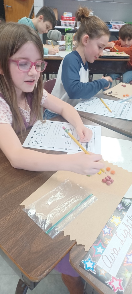 Pictured here are Ms. Ciccarone's 3rd graders practicing fractions of a group with Skittles fractions - this makes math even sweeter!