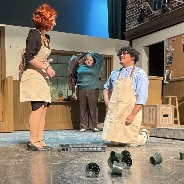 Seymour kneeling in front of Audrey