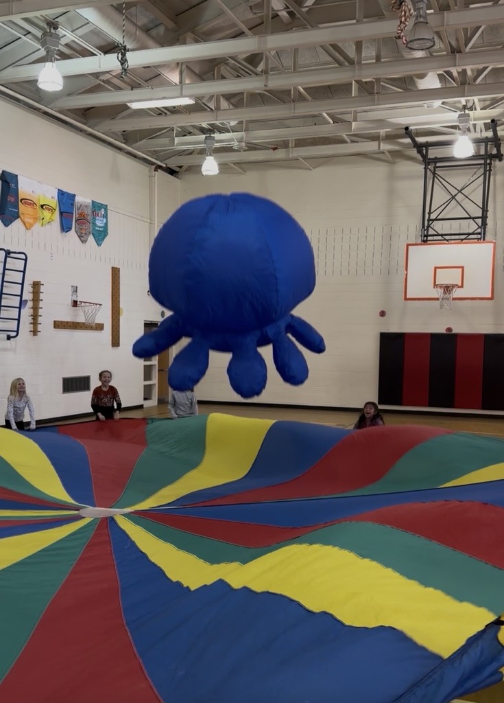 Kindergarteners in Ms. Epstein and Mrs. Henderson classes and  Mrs. Aylor’s 2nd grade class were rewarded today for earning the most tickets in PE for the first semester.  Meet Ollie the Octopus, a new addition to parachute play! 