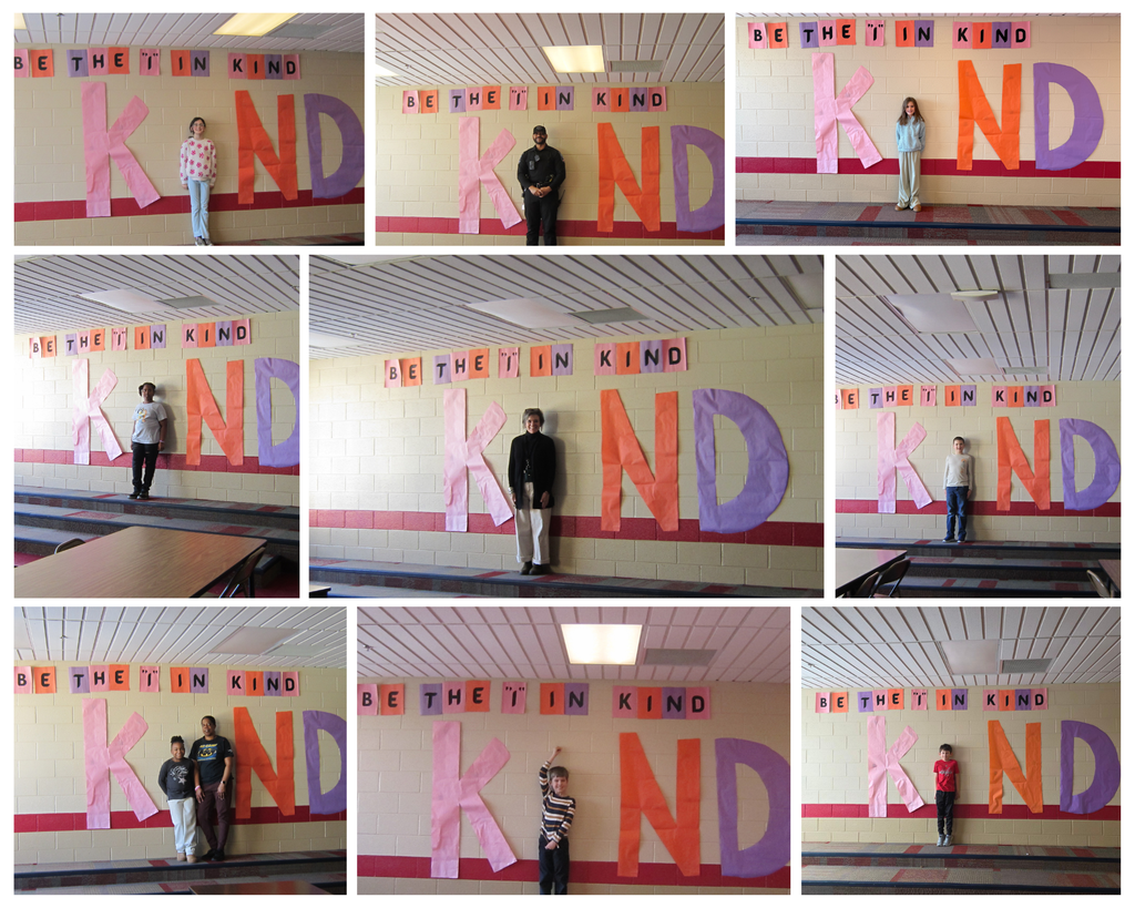 Collage of nine school hallway photos showing students and staff standing beside a large colorful wall display that spells “KIND,” with a banner above reading “BE THE ‘I’ IN KIND.” Each photo features a different person or small group posing next to oversized pink, orange, and purple letters on a cafeteria wall, promoting a kindness theme at school.