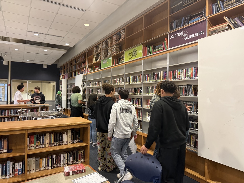 Students walking in a library.
