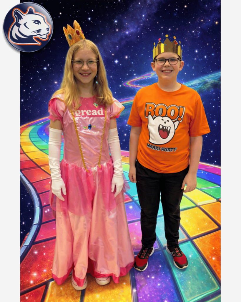 Two students pose on a colorful rainbow road–style background with a starry space theme. One student is dressed as Princess Peach in a pink gown and crown, and the other wears a crown and an orange shirt featuring a Boo ghost from Mario. A Culpeper Middle School logo appears in the top corner.