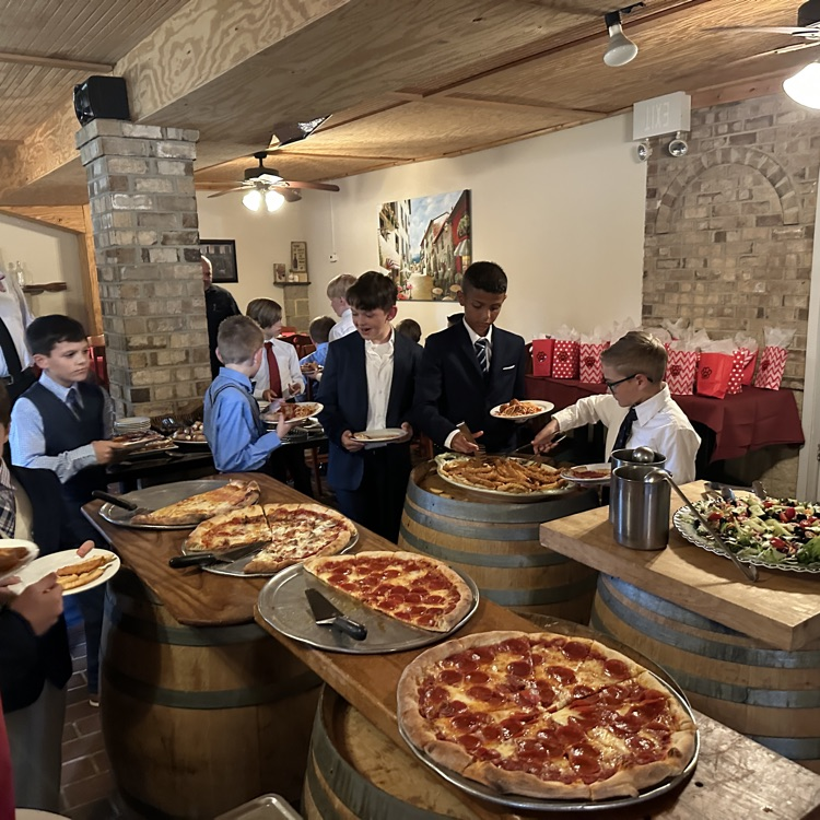 students are pictured here, making their plates and enjoying food at Luigi’s restaurant