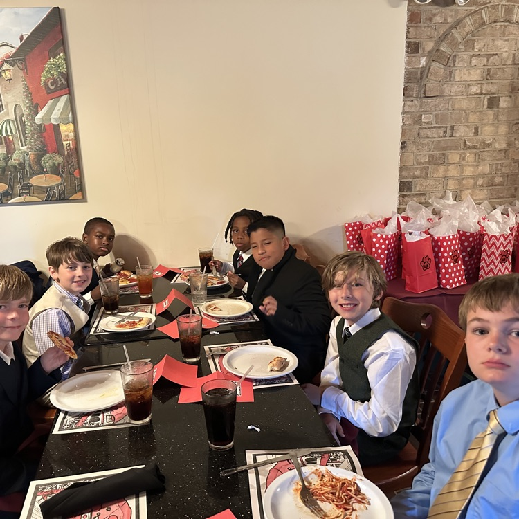 students are pictured here, making their plates and enjoying food at Luigi’s restaurant
