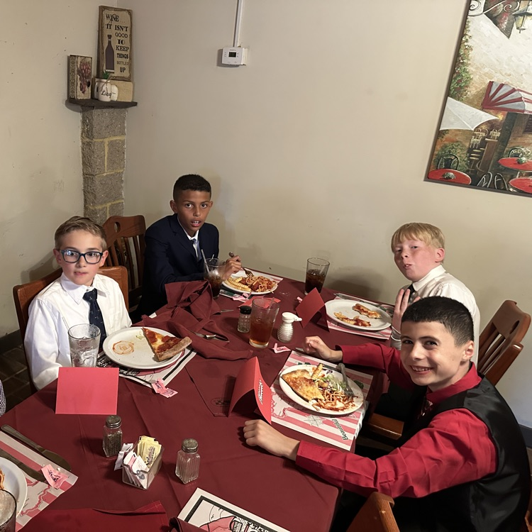 students are pictured here, making their plates and enjoying food at Luigi’s restaurant