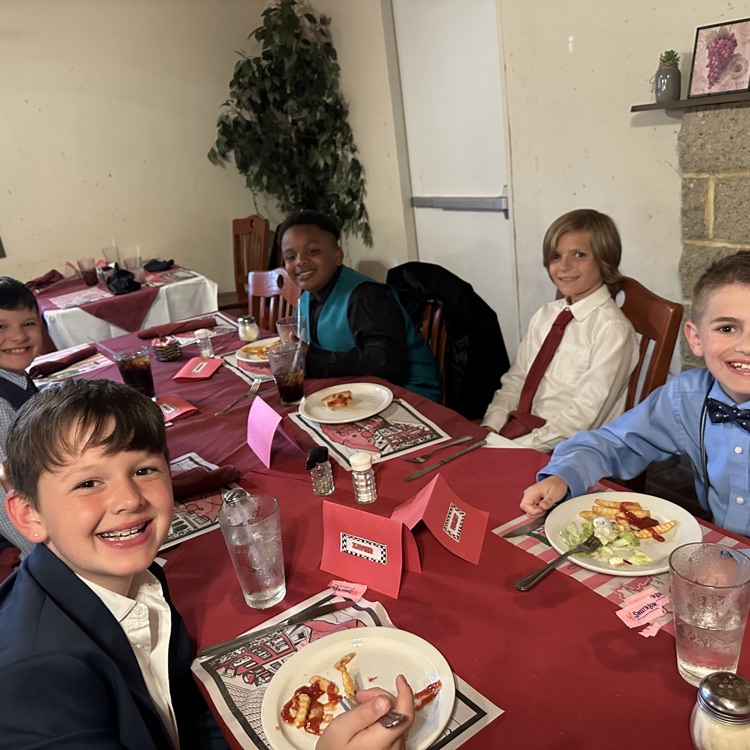 students are pictured here, making their plates and enjoying food at Luigi’s restaurant