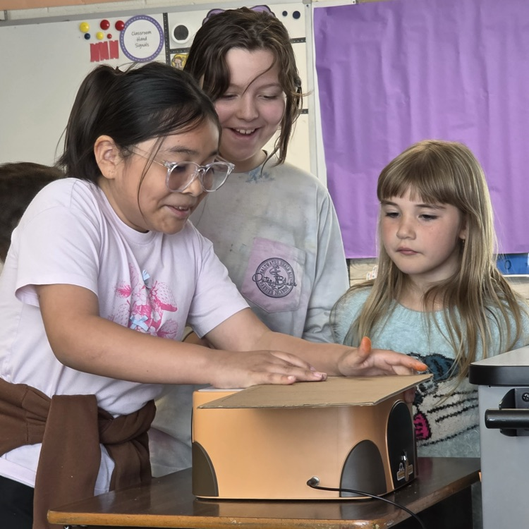 students pictured using beaverbot cardboard cutters in art