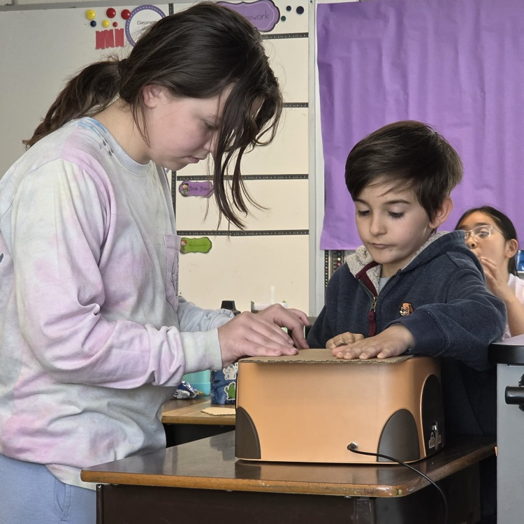 students pictured using beaverbot cardboard cutters in art