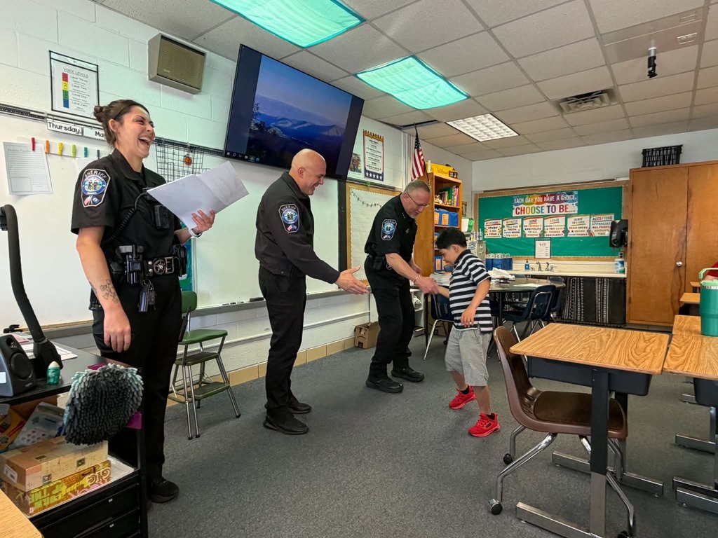 Culpeper County Sheriff’s Office deputies present a D.A.R.E. graduation certificate to a fifth grade student during a classroom ceremony at Farmington Elementary School.