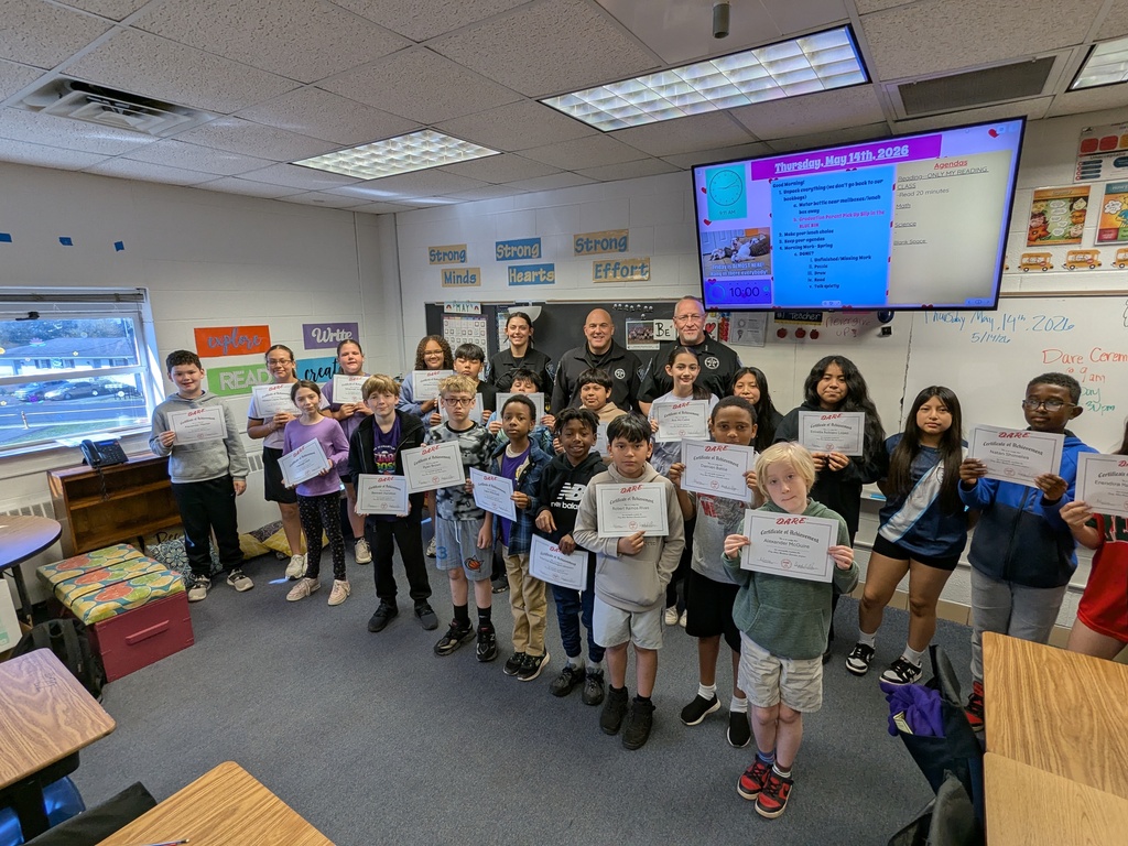 Group photo of Farmington Elementary fifth grade students holding D.A.R.E. graduation certificates alongside Culpeper County Sheriff’s Office deputies and school staff inside a classroom.