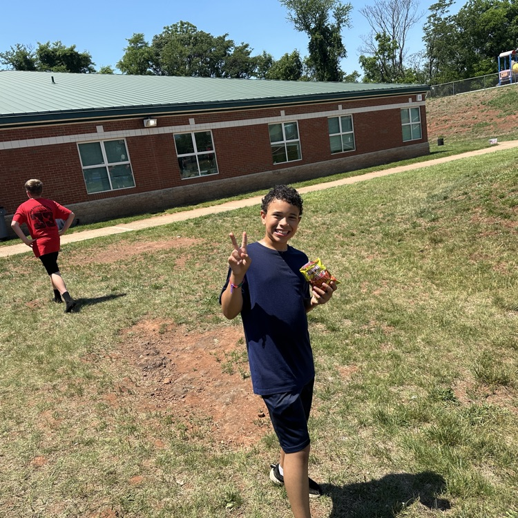 outside fifth grade party showing students enjoying fun and games and food